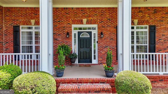 1621 White Oak Cv, Loganville, GA 30052 - view of exterior entry with covered porch and brick siding