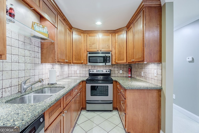 1621 White Oak Cv, Loganville, GA 30052 - kitchen with stainless steel appliances, a sink, tasteful backsplash, light stone counters, and light tile patterned floors
