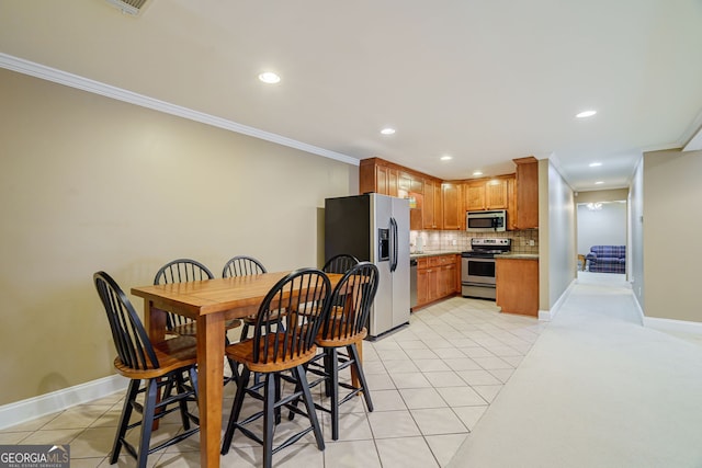 1621 White Oak Cv, Loganville, GA 30052 - dining area with crown molding, light tile patterned floors, recessed lighting, and baseboards