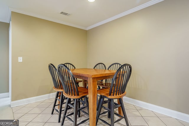 1621 White Oak Cv, Loganville, GA 30052 - dining room featuring crown molding, baseboards, and light tile patterned floors