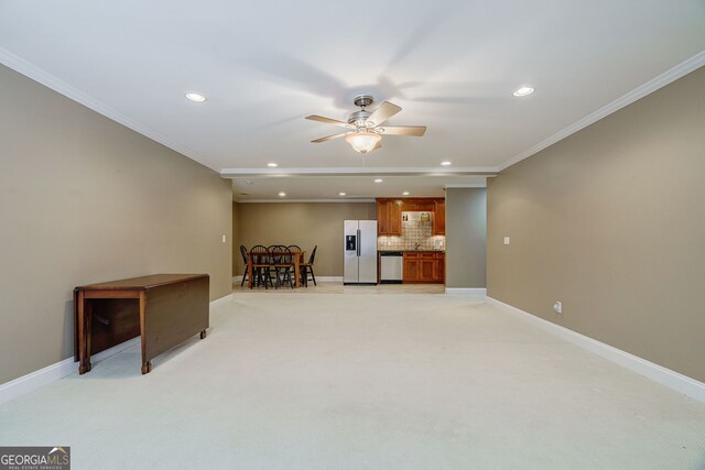 1621 White Oak Cv, Loganville, GA 30052 - unfurnished living room with recessed lighting, a ceiling fan, light carpet, baseboards, and crown molding