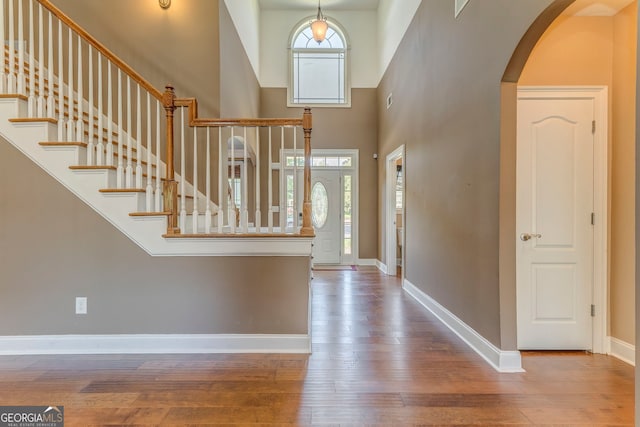 100 Harmony Ct, Dallas, GA 30157 - foyer entrance featuring arched walkways, hardwood / wood-style flooring, baseboards, a high ceiling, and stairway
