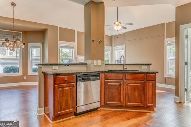 100 Harmony Ct, Dallas, GA 30157 - kitchen featuring dishwasher, a sink, a chandelier, brown cabinets, and lofted ceiling