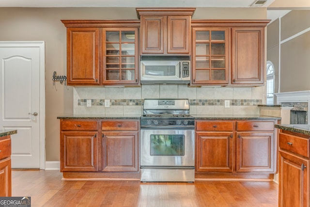 100 Harmony Ct, Dallas, GA 30157 - kitchen featuring appliances with stainless steel finishes, dark stone countertops, and brown cabinetry