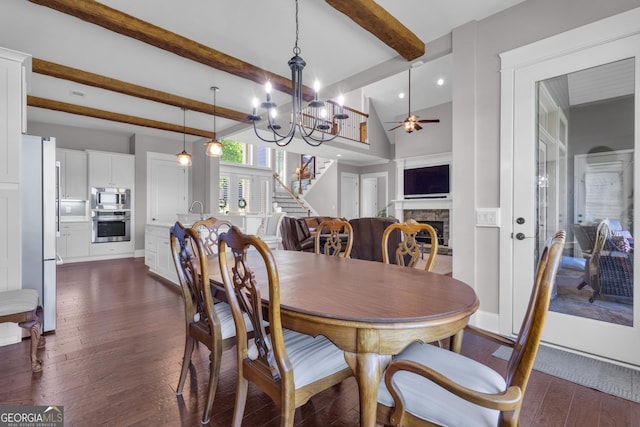 406 Vanderbilt Pkwy, Newnan, GA 30265 - dining room featuring stairs, a stone fireplace, dark wood-type flooring, a ceiling fan, and beamed ceiling