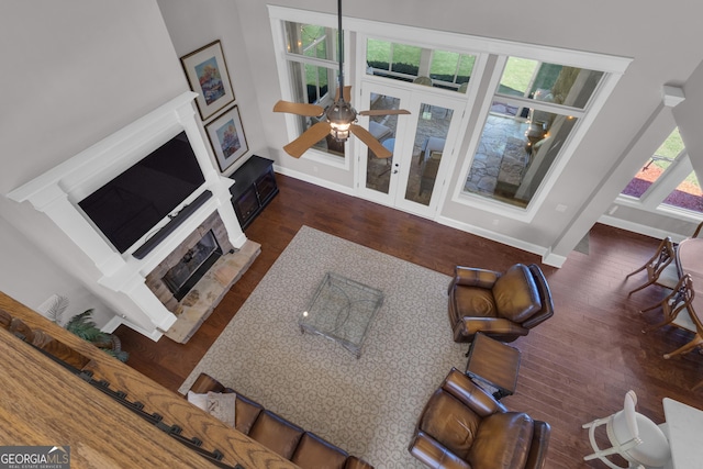 406 Vanderbilt Pkwy, Newnan, GA 30265 - living area with a fireplace with raised hearth, wood finished floors, ceiling fan, and baseboards