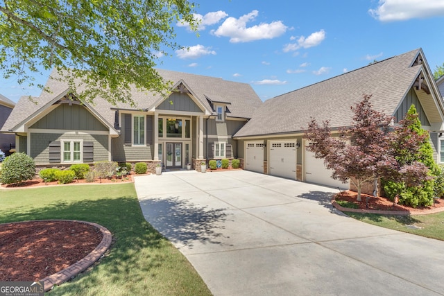 406 Vanderbilt Pkwy, Newnan, GA 30265 - craftsman inspired home featuring a shingled roof, driveway, board and batten siding, an attached garage, and a front lawn