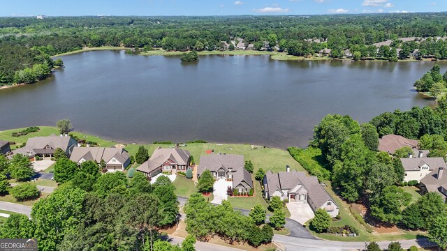 406 Vanderbilt Pkwy, Newnan, GA 30265 - aerial overview of property's location featuring a nearby body of water, nearby suburban area, and a heavily wooded area