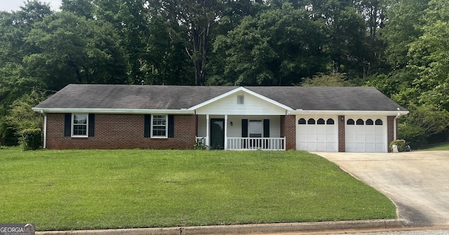3857 Pointers Way SW, Conyers, GA 30094 - single story home featuring a porch, brick siding, a garage, and concrete driveway