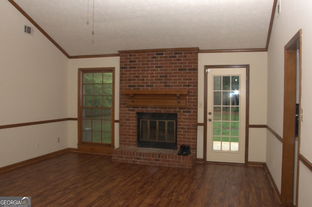 3857 Pointers Way SW, Conyers, GA 30094 - unfurnished living room with crown molding, wood finished floors, lofted ceiling, a brick fireplace, and a textured ceiling