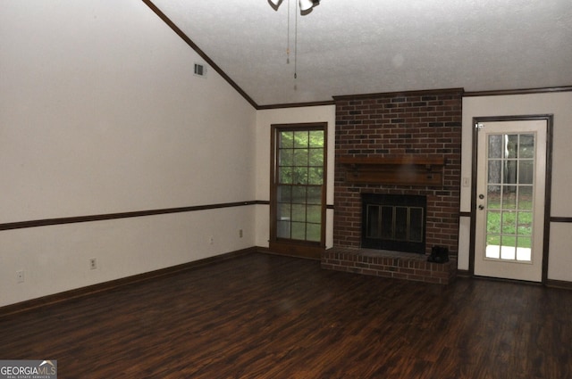 3857 Pointers Way SW, Conyers, GA 30094 - unfurnished living room featuring crown molding, wood finished floors, baseboards, a brick fireplace, and a textured ceiling