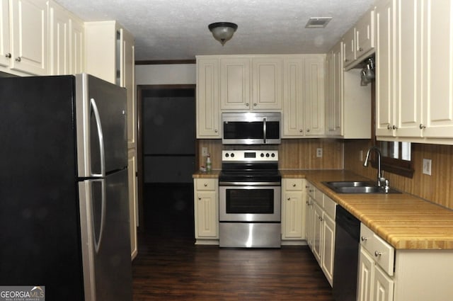 3857 Pointers Way SW, Conyers, GA 30094 - kitchen featuring appliances with stainless steel finishes, a sink, dark wood-type flooring, light countertops, and white cabinets