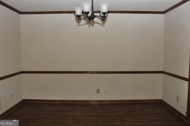 3857 Pointers Way SW, Conyers, GA 30094 - empty room featuring a chandelier, dark wood-style flooring, ornamental molding, and baseboards