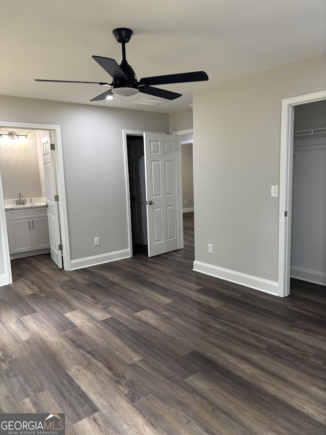 1030 Keller Rd, Mount Airy, GA 30563 - unfurnished bedroom with dark wood-type flooring, a walk in closet, a closet, ensuite bath, and ceiling fan
