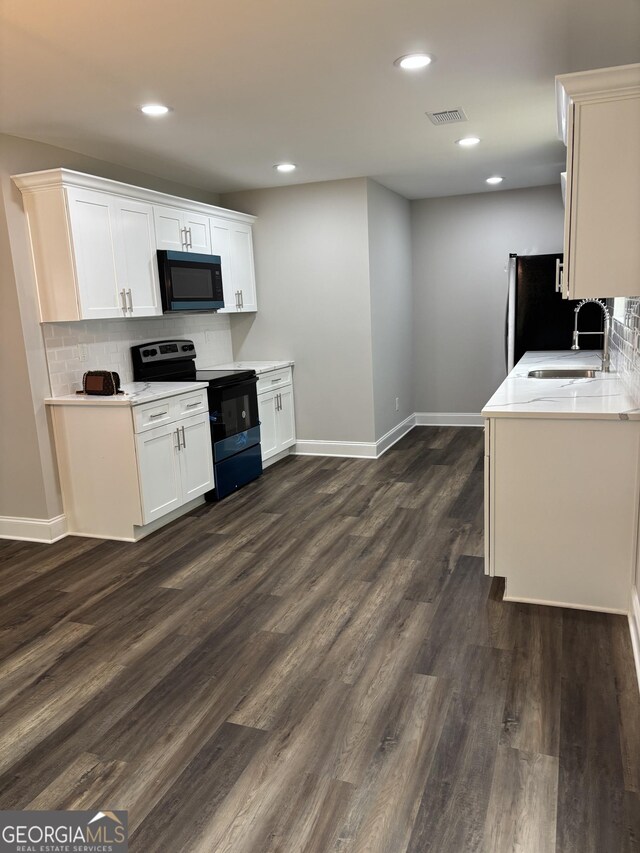 1030 Keller Rd, Mount Airy, GA 30563 - kitchen featuring black appliances, dark wood finished floors, decorative backsplash, recessed lighting, and white cabinets