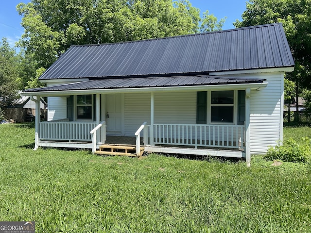 1 E 4th St, Aragon, GA 30104 - view of front facade with a front lawn, metal roof, and a porch