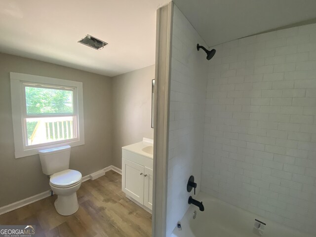 1 E 4th St, Aragon, GA 30104 - bathroom with toilet, vanity, wood finished floors, bathing tub / shower combination, and baseboards