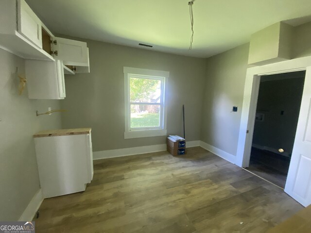 1 E 4th St, Aragon, GA 30104 - unfurnished dining area with baseboards and wood finished floors