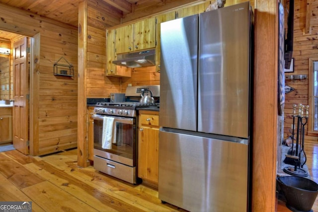 355 Cohutta Mountain Rd, Cherry Log, GA 30522 - kitchen featuring appliances with stainless steel finishes, under cabinet range hood, wood walls, light wood finished floors, and dark countertops