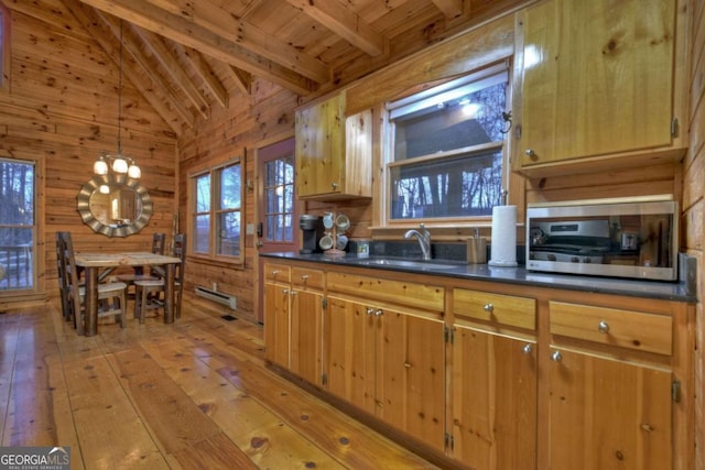 355 Cohutta Mountain Rd, Cherry Log, GA 30522 - kitchen featuring wooden ceiling, dark countertops, light wood-style flooring, wooden walls, and pendant lighting