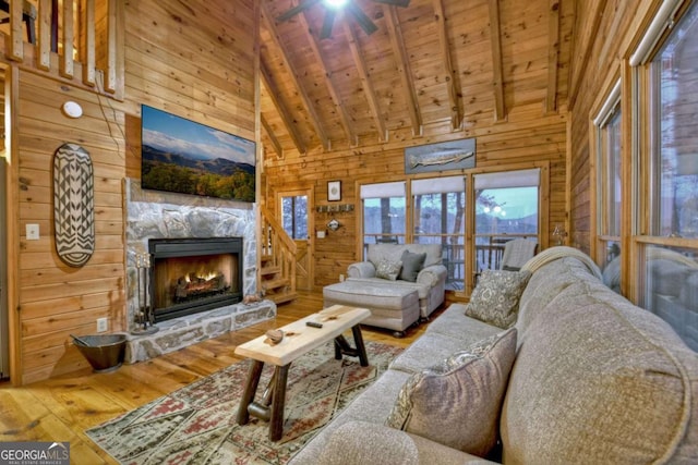 355 Cohutta Mountain Rd, Cherry Log, GA 30522 - living room with wooden walls, hardwood / wood-style flooring, wood ceiling with exposed beams, a fireplace, and high vaulted ceiling