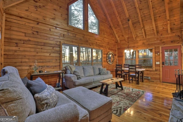355 Cohutta Mountain Rd, Cherry Log, GA 30522 - living area with high vaulted ceiling, wooden walls, hardwood / wood-style flooring, wooden ceiling with exposed beams, and a chandelier