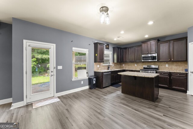 240 Somerset Dr, Dallas, GA 30132 - kitchen featuring appliances with stainless steel finishes, dark brown cabinetry, backsplash, light wood-style floors, and recessed lighting