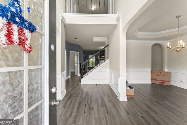 240 Somerset Dr, Dallas, GA 30132 - foyer featuring arched walkways, wood finished floors, a wainscoted wall, a chandelier, and crown molding