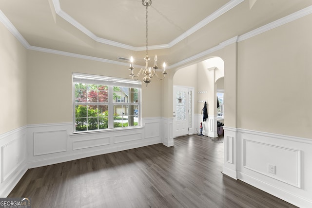 240 Somerset Dr, Dallas, GA 30132 - unfurnished dining area featuring arched walkways, a wainscoted wall, a raised ceiling, a chandelier, and dark wood finished floors
