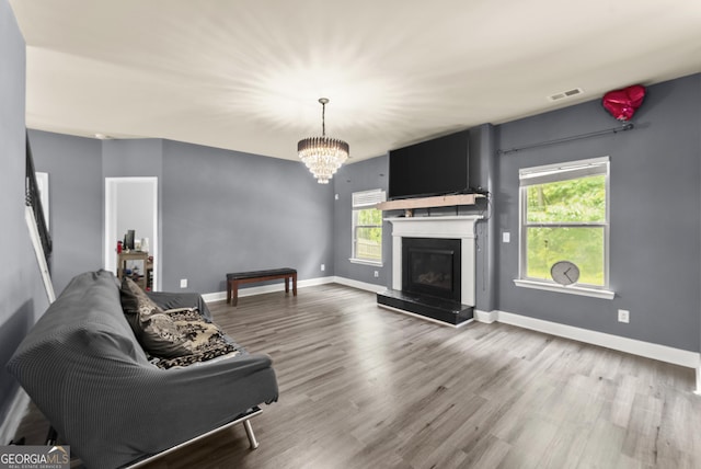 240 Somerset Dr, Dallas, GA 30132 - living area with healthy amount of natural light, wood finished floors, a chandelier, and baseboards