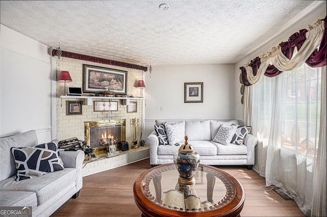 3244 Hampton Ct, Smyrna, GA 30082 - living area featuring a textured ceiling, wood finished floors, and a fireplace