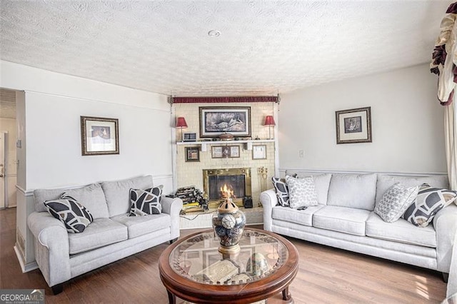 3244 Hampton Ct, Smyrna, GA 30082 - living area with a textured ceiling, wood finished floors, and a fireplace