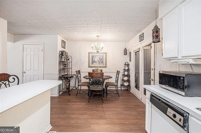 3244 Hampton Ct, Smyrna, GA 30082 - dining area featuring dark wood-style flooring, a chandelier, and a textured ceiling