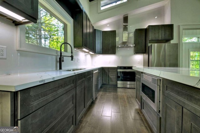 840 Arp Rd, Mineral Bluff, GA 30559 - kitchen with wall chimney exhaust hood, stainless steel appliances, a sink, light stone countertops, and dark wood-style floors
