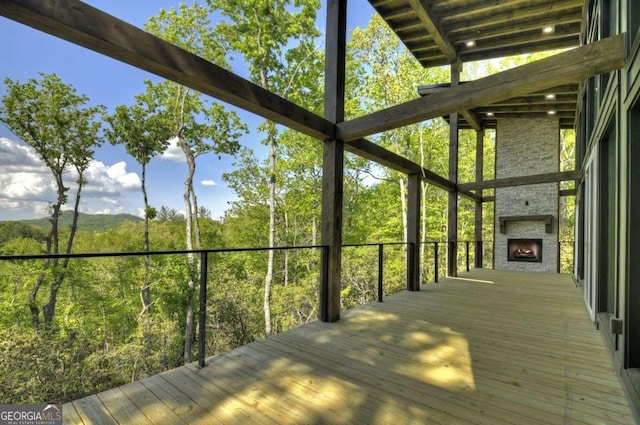 840 Arp Rd, Mineral Bluff, GA 30559 - wooden terrace with a fireplace and a view of trees