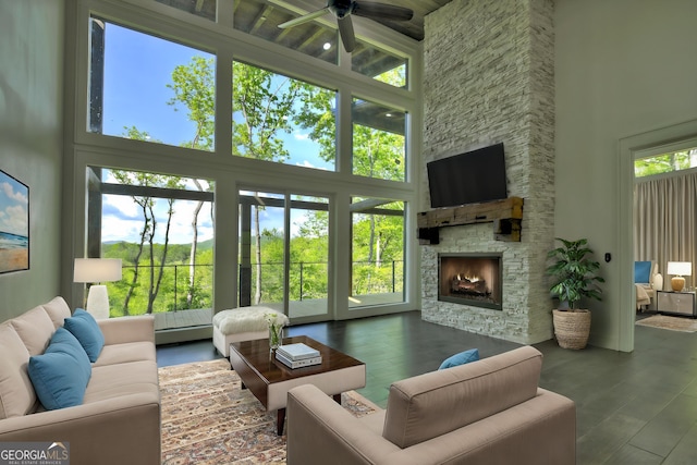840 Arp Rd, Mineral Bluff, GA 30559 - living area featuring a high ceiling, ceiling fan, a stone fireplace, and wood finished floors