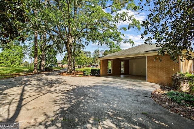 315 Burke Cir, Mcdonough, GA 30253 - view of home's exterior featuring concrete driveway, brick siding, and an attached carport
