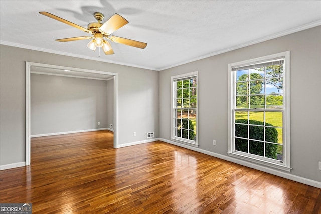 315 Burke Cir, Mcdonough, GA 30253 - spare room featuring crown molding, wood finished floors, ceiling fan, and baseboards