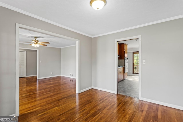 315 Burke Cir, Mcdonough, GA 30253 - spare room with dark wood-style floors, crown molding, baseboards, and a ceiling fan