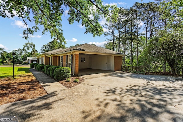 315 Burke Cir, Mcdonough, GA 30253 - view of side of property with brick siding, concrete driveway, and an attached carport