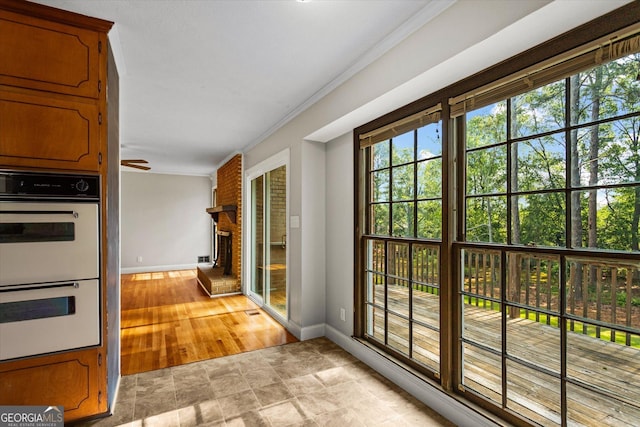 315 Burke Cir, Mcdonough, GA 30253 - entryway with baseboards, a brick fireplace, crown molding, and ceiling fan