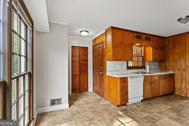 315 Burke Cir, Mcdonough, GA 30253 - kitchen featuring dishwasher, light countertops, baseboards, brown cabinetry, and a sink