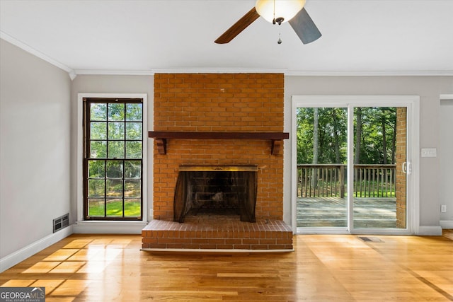 315 Burke Cir, Mcdonough, GA 30253 - unfurnished living room with wood finished floors, crown molding, baseboards, a ceiling fan, and a fireplace