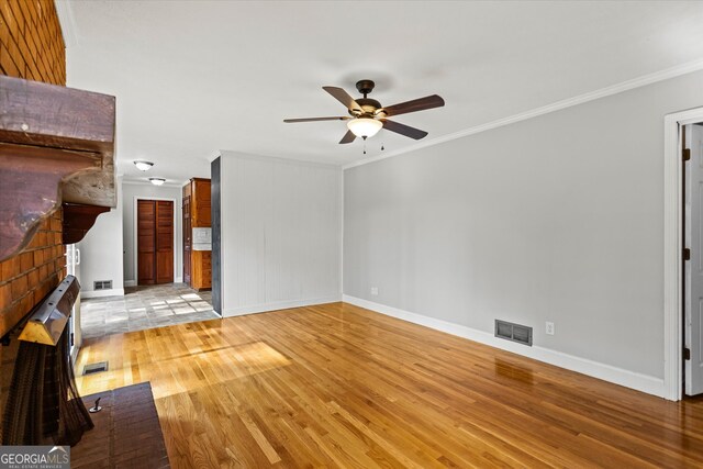 315 Burke Cir, Mcdonough, GA 30253 - unfurnished living room with crown molding, a ceiling fan, wood finished floors, and baseboards
