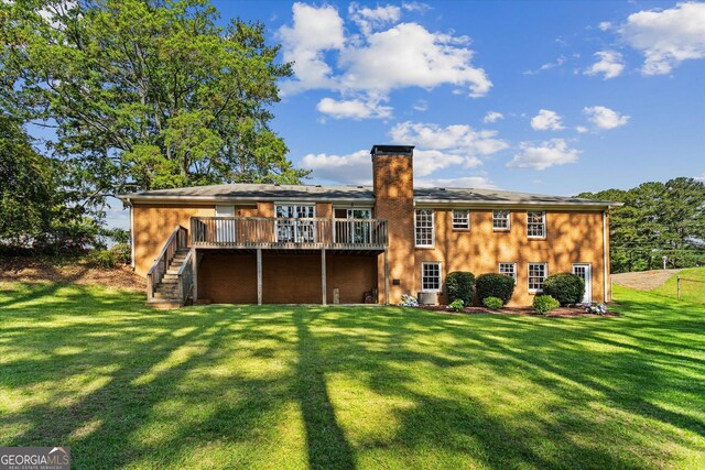 315 Burke Cir, Mcdonough, GA 30253 - back of property featuring stairway, a wooden deck, a chimney, and a yard