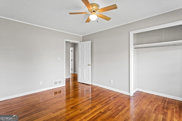 315 Burke Cir, Mcdonough, GA 30253 - unfurnished bedroom featuring wood finished floors, crown molding, a closet, baseboards, and a ceiling fan