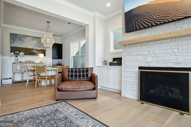 247 Widener Way, Peachtree City, GA 30269 - living area with ornamental molding, a baseboard heating unit, light wood finished floors, a chandelier, and a fireplace