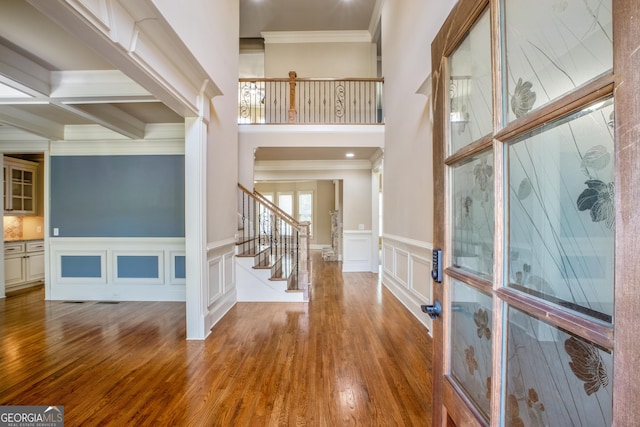 2604 Heltonwood Ct, Buford, GA 30519 - foyer entrance featuring crown molding, stairs, wood finished floors, a decorative wall, and a wainscoted wall