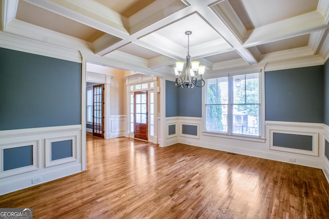 2604 Heltonwood Ct, Buford, GA 30519 - unfurnished living room with a chandelier, coffered ceiling, beam ceiling, wood finished floors, and wainscoting
