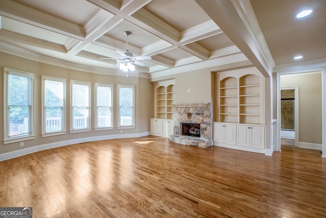 2604 Heltonwood Ct, Buford, GA 30519 - unfurnished living room with baseboards, a stone fireplace, wood finished floors, a ceiling fan, and built in features